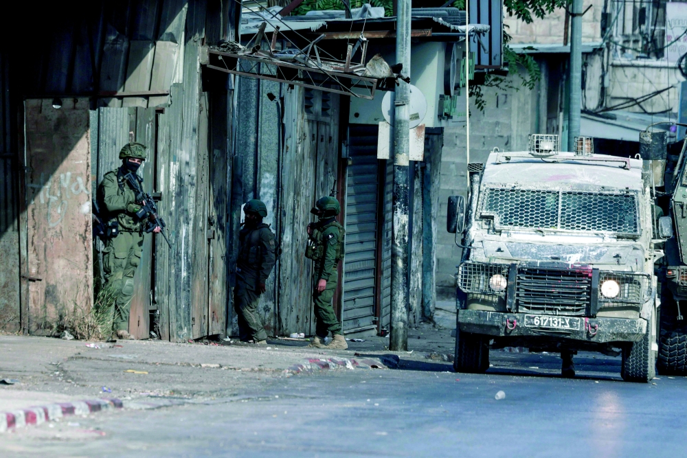Israeli troops deploy during a raid in Nablus city in the occupied West Bank. — AFP