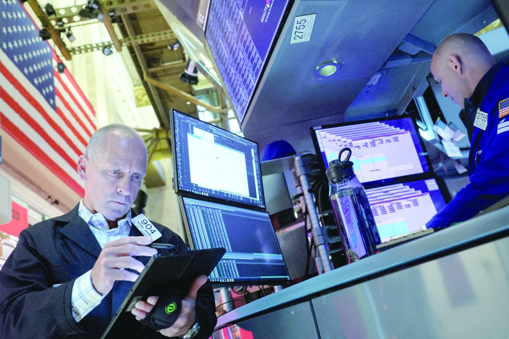 Traders work on the floor of the NYSE in New York. — REUTERS