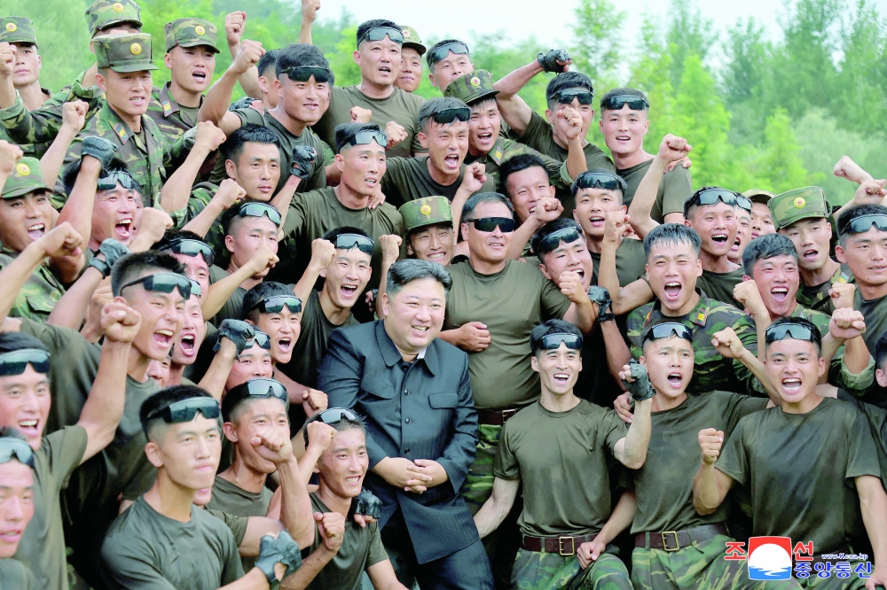North Korean leader Kim Jong Un with troops during a visit to a special operation training base at an undisclosed location. - Reuters