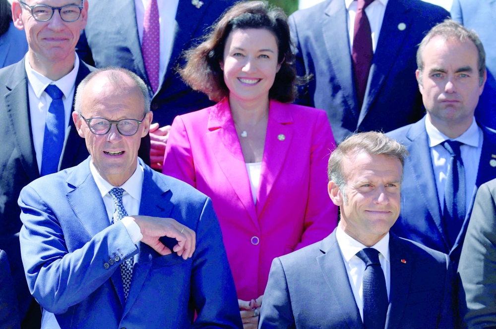 French President Emmanuel Macron (front, R) and German Chancellor Friedrich Merz (front L) pose with members of their government for a family photo after a plenary session of the 25th Franco-German cabinet meeting in Toulon, south-eastern France, on August 29, 2025. (Photo by Manon Cruz / POOL / AFP)