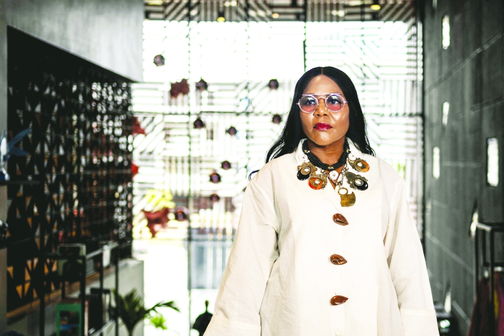 Reni Folawiyo, founder of Alara concept store, poses for a photograph inside Alara in Lagos, on August 20, 2025. With its modern red and black architecture, Al疵a, West Africa's first luxury fashion and decor concept store, stands out in the Nigerian megacity of Lagos. Ten years in business, the store has established itself as a temple of Afro-luxury under the vision of its founder, businesswoman Reni Folawiyo. (Photo by OLYMPIA DE MAISMONT / AFP)
