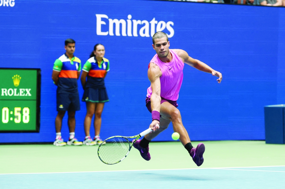 Spain's Carlos Alcaraz hits a return to Italy's Luciano Darderi during their men's singles third round match on day six of the US Open tennis tournament. — AFP