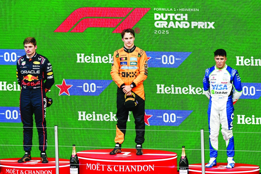 Second-placed Red Bull Racing's Dutch driver Max Verstappen, winner McLaren's Australian driver Oscar Piastri and third-placed RB's French driver Isack Hadjar celebrate on the podium following the Formula One Dutch Grand Prix at The Circuit Zandvoort, western Netherlands. — AFP