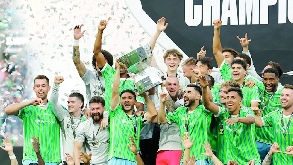 Seattle Sounders players celebrate winning the Leagues Cup trophy after the match