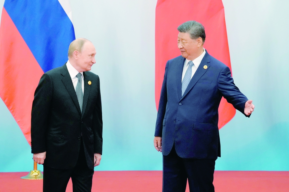 Chinese President Xi Jinping (R) shows the way to Russian President Vladimir Putin, at the Meijiang Convention and Exhibition Centre in Tianjin. — AFP