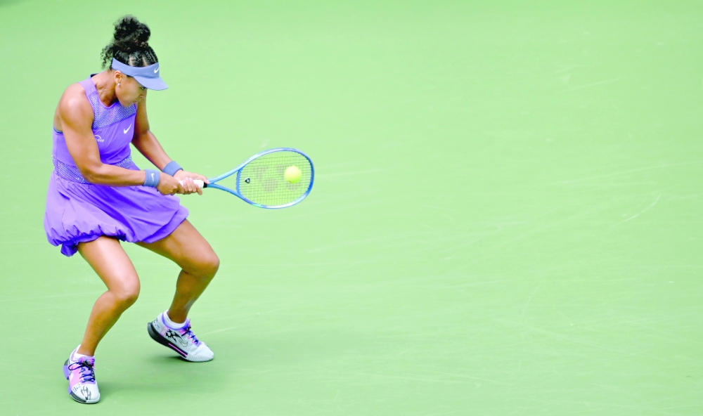 Japan's Naomi Osaka returns the ball to USA's Coco Gauff during their women's singles round of 16 tennis match on day nine of the US Open tennis tournament at the USTA Billie Jean King National Tennis Center in New York City, on September 1, 2025. 