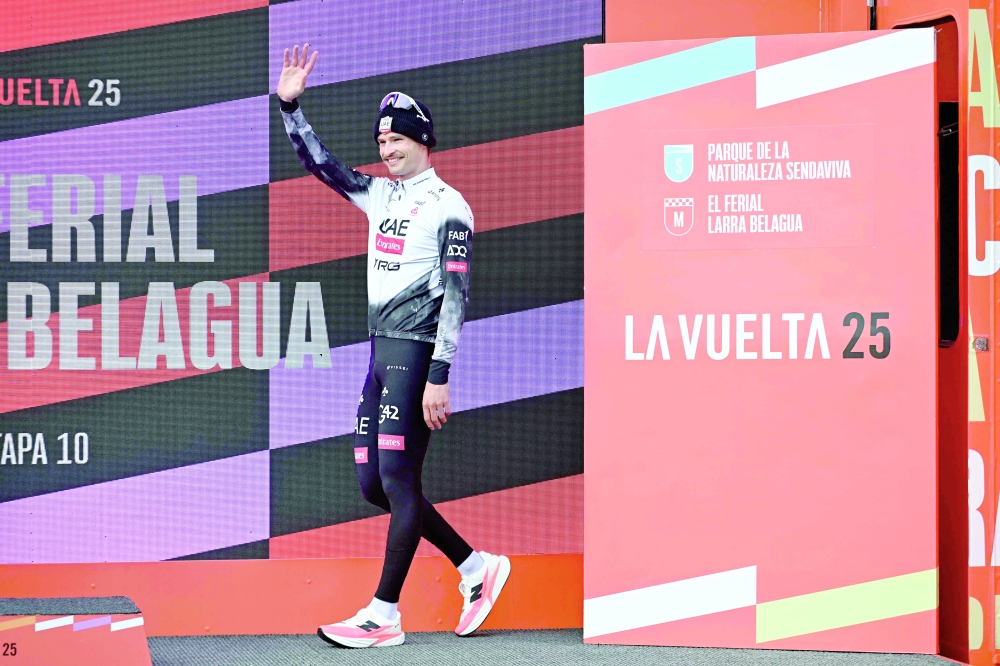 Team UAE's Australian rider Jay Vine waves from the podium after winning the tenth stage of the Vuelta a Espana cycling tour, a 168 km race between Sendaviva Natural Park in Arguedas and El Ferial Larra Belagua in Isaba. — AFP