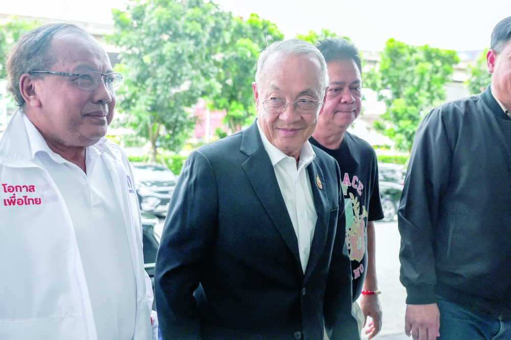 Chaikasem Nitisiri, Pheu Thai party's remaining prime ministerial candidate, arrives at the party's headquarters, in Bangkok. — Reuters