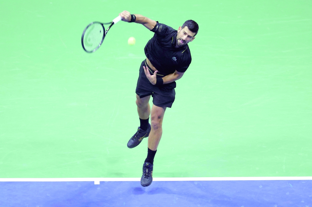 Serbia's Novak Djokovic serves to USA's Taylor Fritz during their men's singles quarterfinal tennis match on day ten of the US Open tennis tournament at the USTA Billie Jean King National Tennis Center in New York City. — AFP