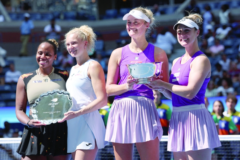Canada's Gabriela Dabrowski and New Zealand's Erin Routliffe  pose with the trophy after winning the women's doubles final against Czech Republic's Katerina Siniakova and Taylor Townsend of the US. — Reuters