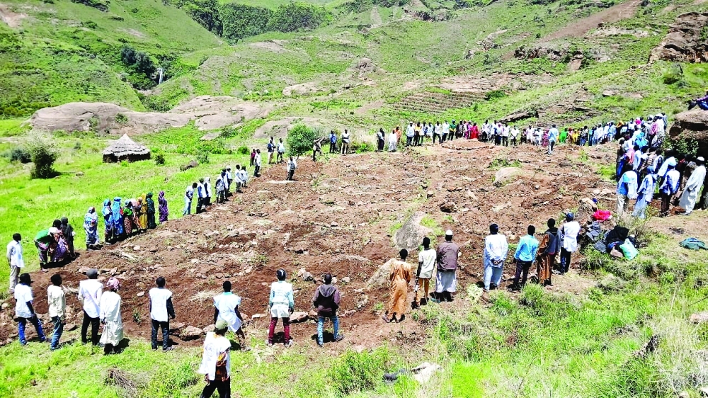 People gather after a landslide destroyed Tarasin village, in Sudan. — Reuters file photo