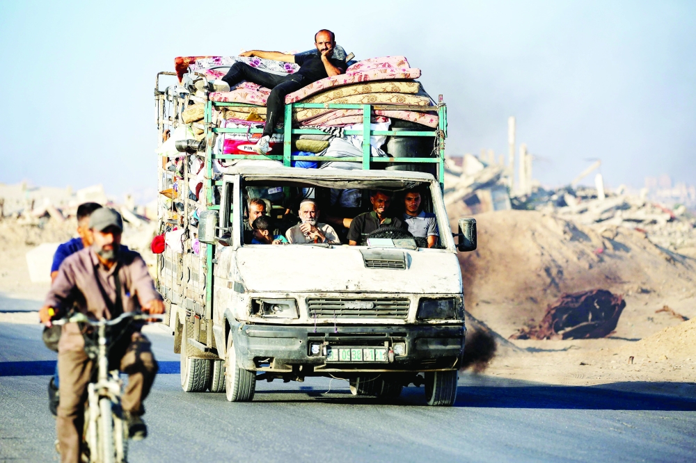 Palestinians fleeing south ride a truck with their belongings. — AFP