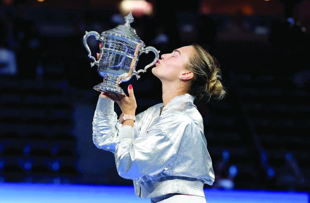 Belarus's Aryna Sabalenka kisses the trophy after defeating USA's Amanda Anisimova during their women's singles final tennis match on day fourteen of the US Open tennis tournament. — AFP 