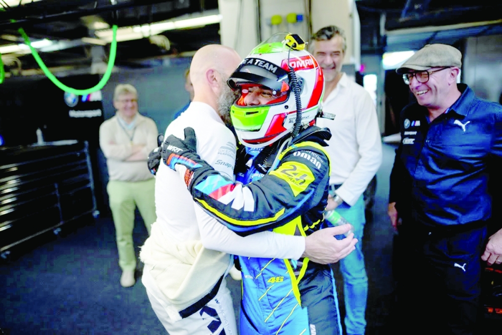Al Harthy celebrates with team-mates after the race