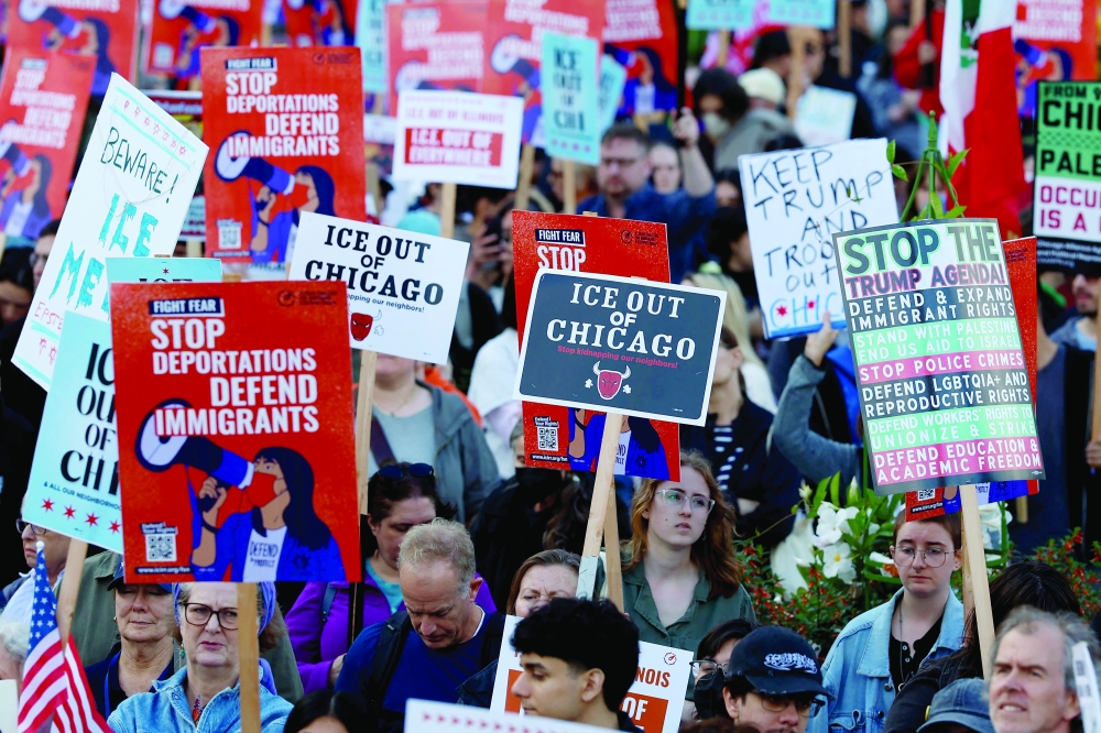 People participate in a demonstration against the planned deployment of National Guard troops in Chicago. — AFP