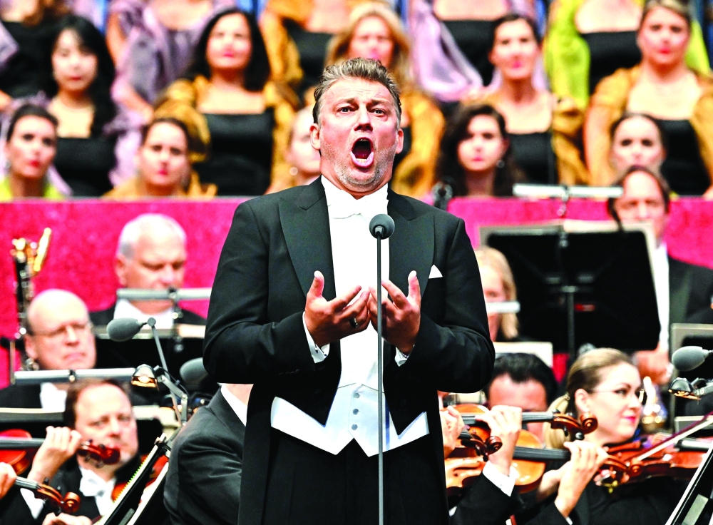 French lyric tenor Benjamin Bernheim performs on stage with his colleague artists of the Vienna State opera during the opening of the 2025-26 season with a free admission open-air gala, outside of the Imperial Hofburg palace at Burg garden in Vienna, Austria, on October 7, 2025. No dress code, no stiff atmosphere and no entry fees: Thousands flocked to a Viennese park on September 7, 2025 as the Vienna State Opera celebrated the opening of its 2025-26 season for the first time ever with a star-studded open-air gala concert. (Photo by Joe Klamar / AFP)

