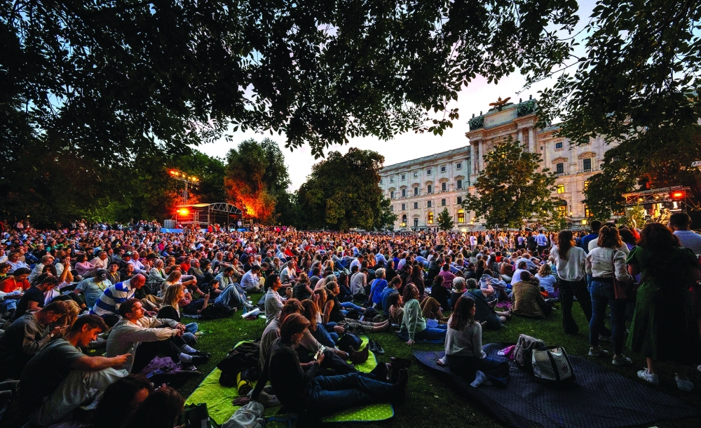 Thousands of music fans listen to Latvian mezzo-soprano Elina Garanca as she performs on stage with her colleague artists of the Vienna State opera during the opening of the 2025-26 season with a free admission open-air gala, outside of the Imperial Hofburg palace at Burg garden in Vienna, Austria, on October 7, 2025. No dress code, no stiff atmosphere and no entry fees: Thousands flocked to a Viennese park on September 7, 2025 as the Vienna State Opera celebrated the opening of its 2025-26 season for the first time ever with a star-studded open-air gala concert. (Photo by Joe Klamar / AFP)
