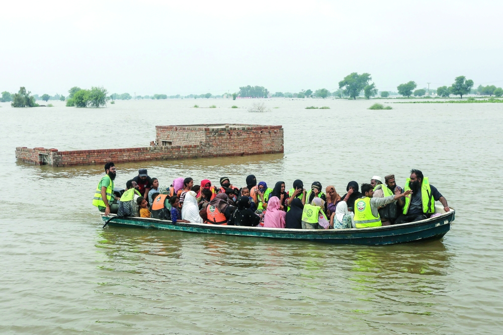 Volunteers rescue flood-affected villagers by boat in Jalalpur Pirwala Tehsil of Multan district in Punjab province on September 8, 2025, after the Chenab River overflowed following heavy monsoon rains. Monsoon rains over the past week swelled three major rivers that cut through Punjab province, Pakistan's agricultural heartland and home to nearly half of its 255 million people. (Photo by Shahid Saeed MIRZA / AFP)
