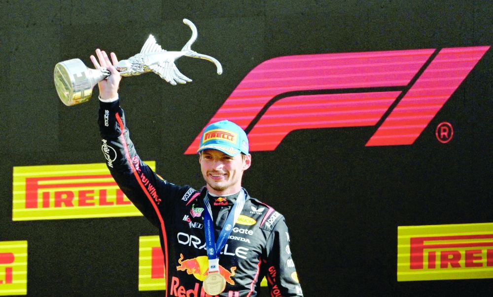 Red Bull's Max Verstappen celebrates on the podium with the trophy after winning the Italian Grand Prix. — Reuters