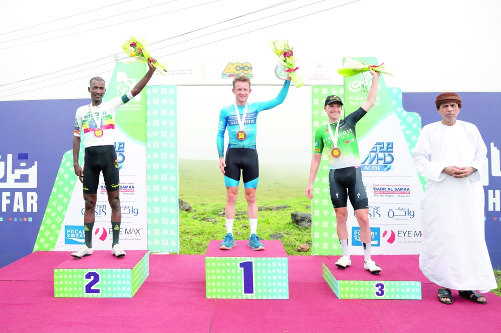 The top three riders pose on the podium.