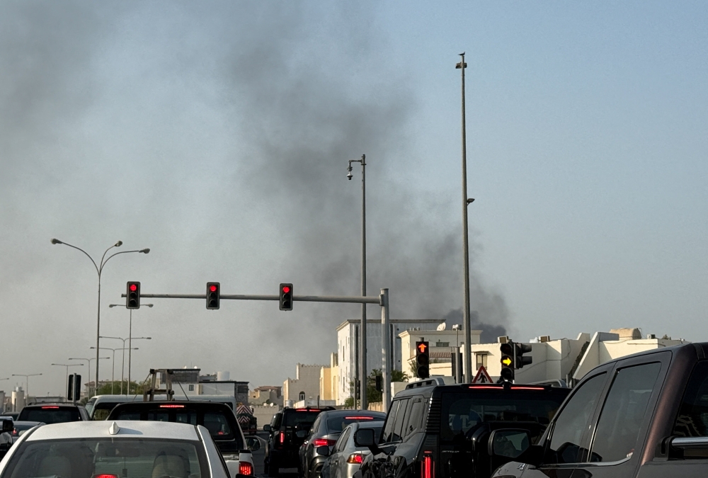Smoke rises after several blasts were heard in Doha