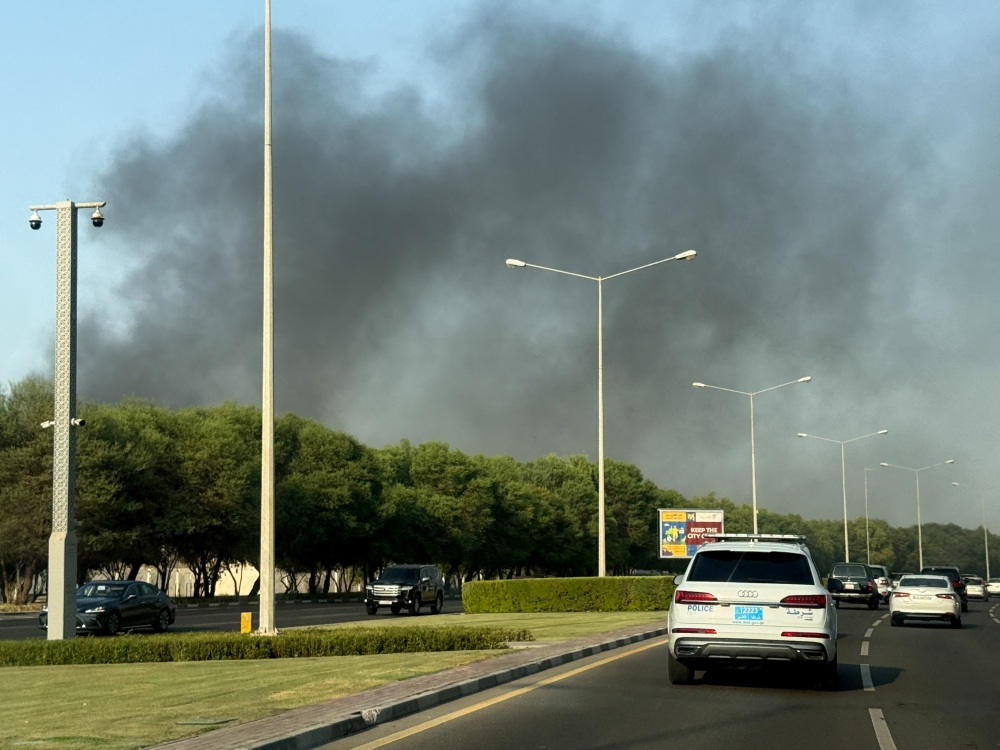 Smoke rises after several blasts were heard in Doha