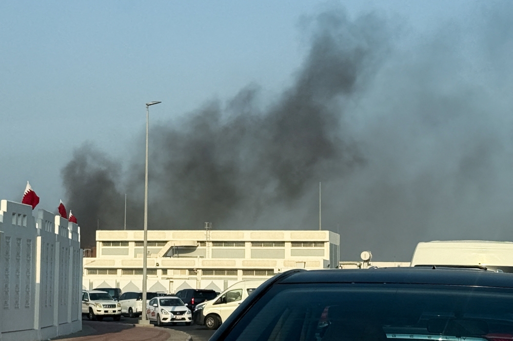 Smoke rises after several blasts were heard in Doha