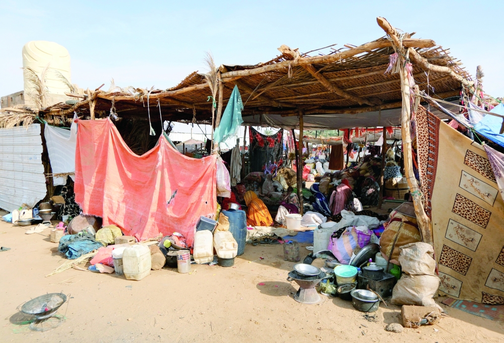 Sudanese women sit in a tent at a displacement camp, in Al Dabba. — Reuters