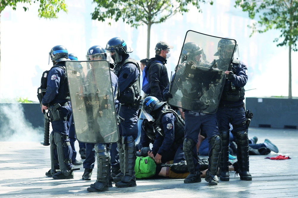 French police pin protesters to the ground during a demonstration, in Montpellier, France. — Reuters