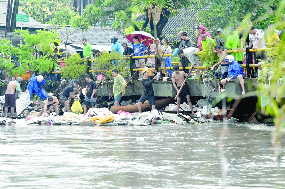 Flood-affected Residents clear clogged debris