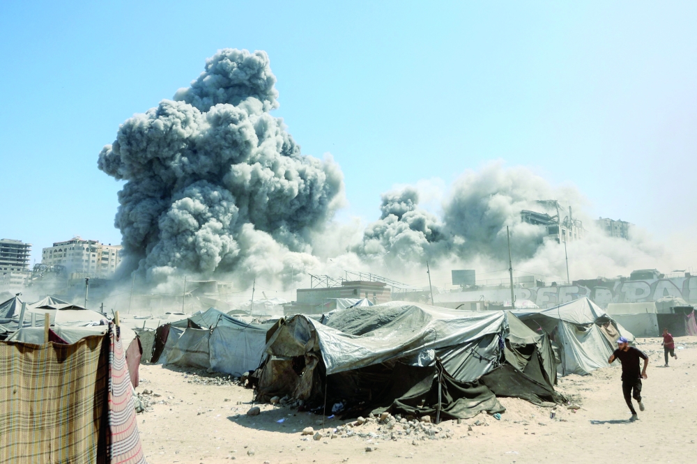 Smoke billows in Gaza City after Israeli strikes on Tiba tower. — AFP