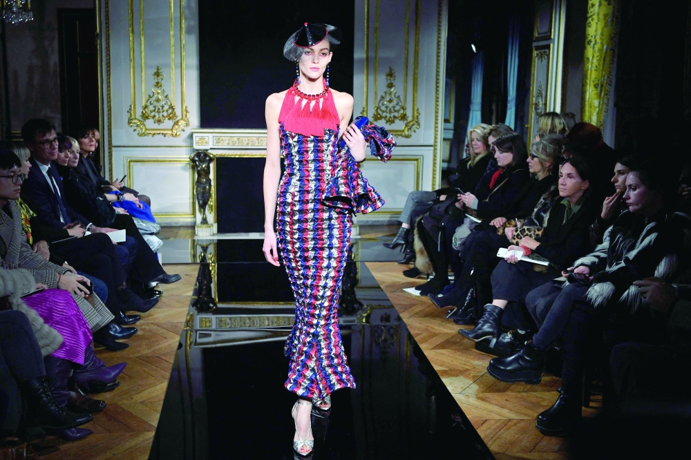A model presents a creation by Giorgio Armaniduring the 2019 Spring-Summer Haute Couture collection fashion show in Paris, on January 22, 2019. Italian fashion great Giorgio Armani has died at the age of 91 "surrounded by his loved ones", his company said on September 4, 2025. (Photo by Anne-Christine POUJOULAT / AFP)
