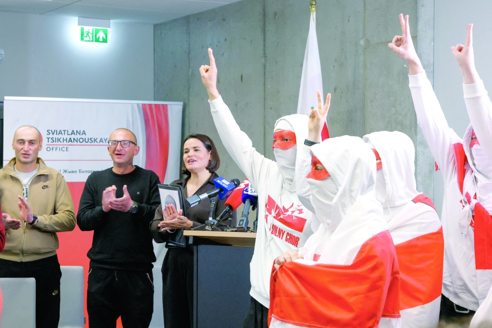 Members of Volny Chor, flash V-signs as exiled Belarusian opposition leader Sviatlana Tsikhanouskaya and prisoners released from Belarus applaud during a press conference in Vilnius. — Reuters
