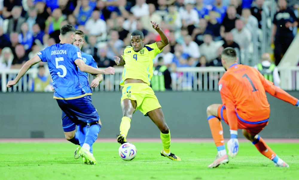 Sweden's Alexander Isak in action with Kosovo's Aro Muric and Lumbardh Dellova in Pristina, Kosovo, on September 8. — Reuters
