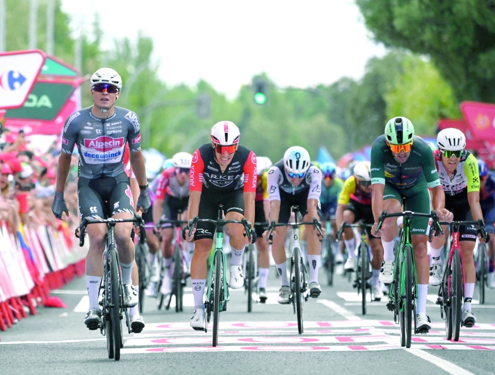 Stage winner team Alpecin's Belgian rider Jasper Philipsen (L) celebrates crossing first the finish line of the 19th stage of the Vuelta a Espana, a 159 km race between Rueda and Guijuelo, on September 12, 2025.   (Photo by Miguel RIOPA / AFP)
