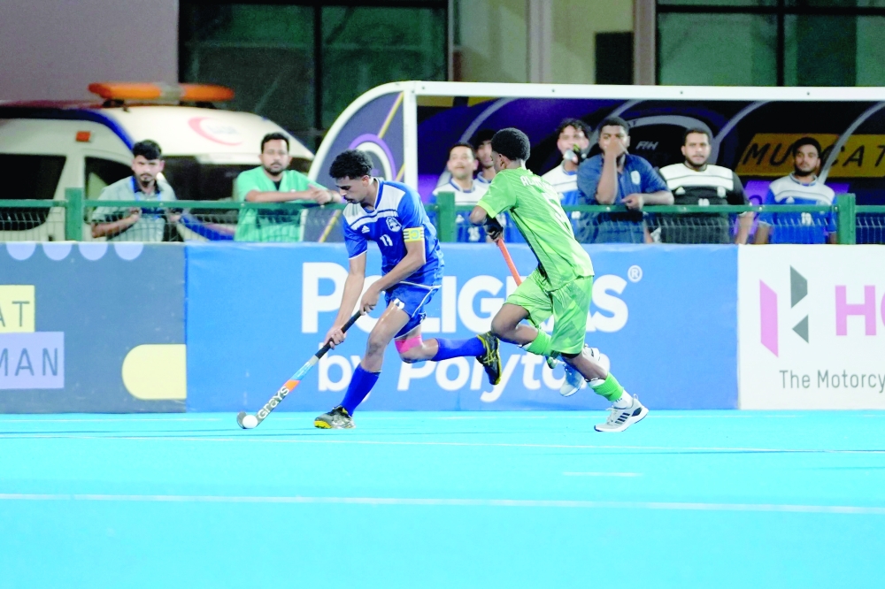 Al Nahda and Saham players fight for the ball