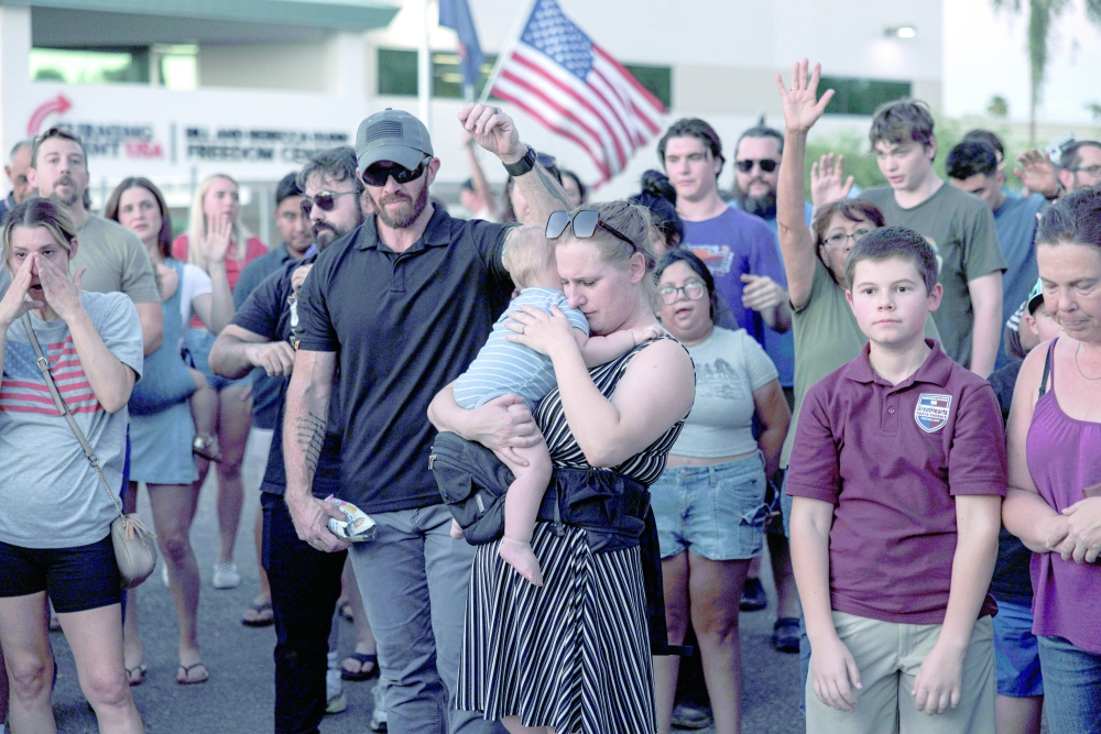 Mourners at an impromptu memorial to Charlie Kirk, in Phoenix.