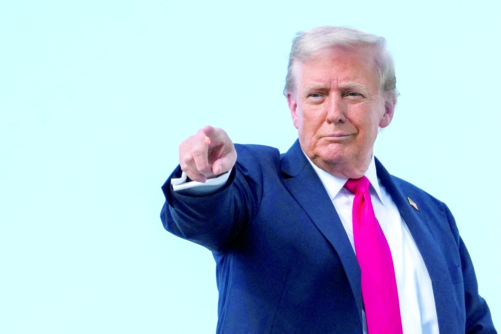 US President Donald Trump gestures, while he boards Air Force One, in Maryland. — Reuters