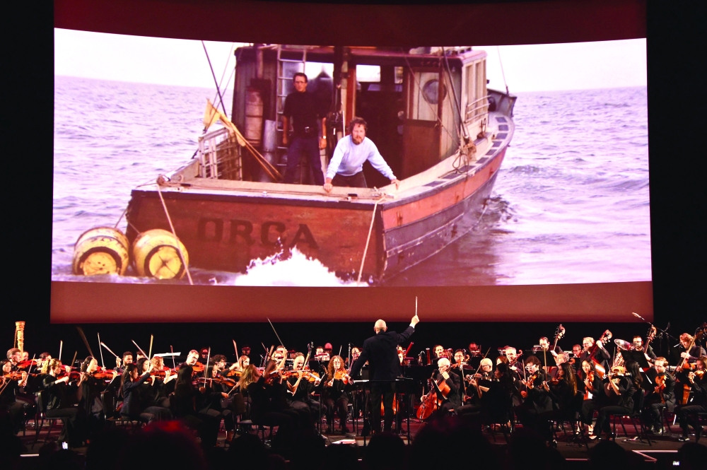 Conductor Richard Kaufman leads the orchestra during a media preview of “Jaws: The Exhibition” at the Academy Museum of Motion Pictures in Los Angeles on September 10, 2025.