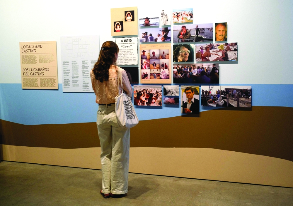 An attendee looks at art during a media preview of “Jaws: The Exhibition” at the Academy Museum of Motion Pictures in Los Angeles on September 10, 2025.