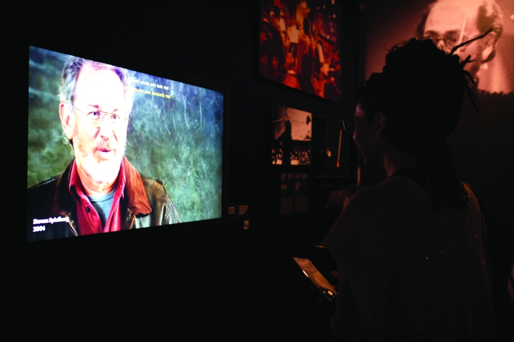 An attendee watches an interview of US filmmaker Steven Spielberg during a media preview of “Jaws: The Exhibition” at the Academy Museum of Motion Pictures in Los Angeles on September 10, 2025.