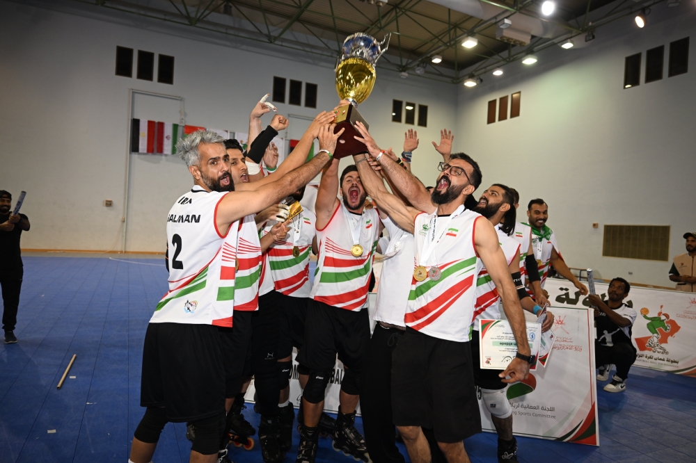 The Iranian team Monsef celebrate with the trophy after winning the third edition of the Oman Roll Ball Championship title