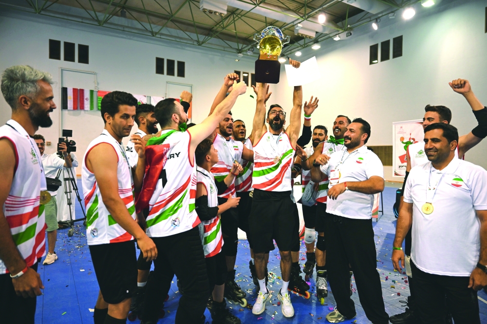 The Iranian team Monsef celebrate with the trophy after winning the third edition of the Oman Roll Ball championship title