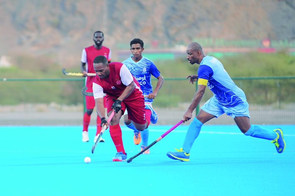 Dhofar and Masirah players fight for the ball.