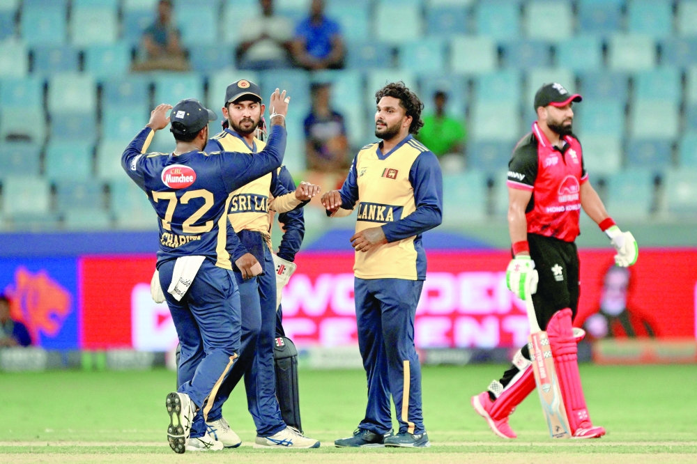 Sri Lanka's Wanindu Hasaranga (C) celebrates with teammates after taking the wicket of Hong Kong's Babar Hayat (R) during the Asia Cup 2025 Twenty20 match in Dubai. — AFP
