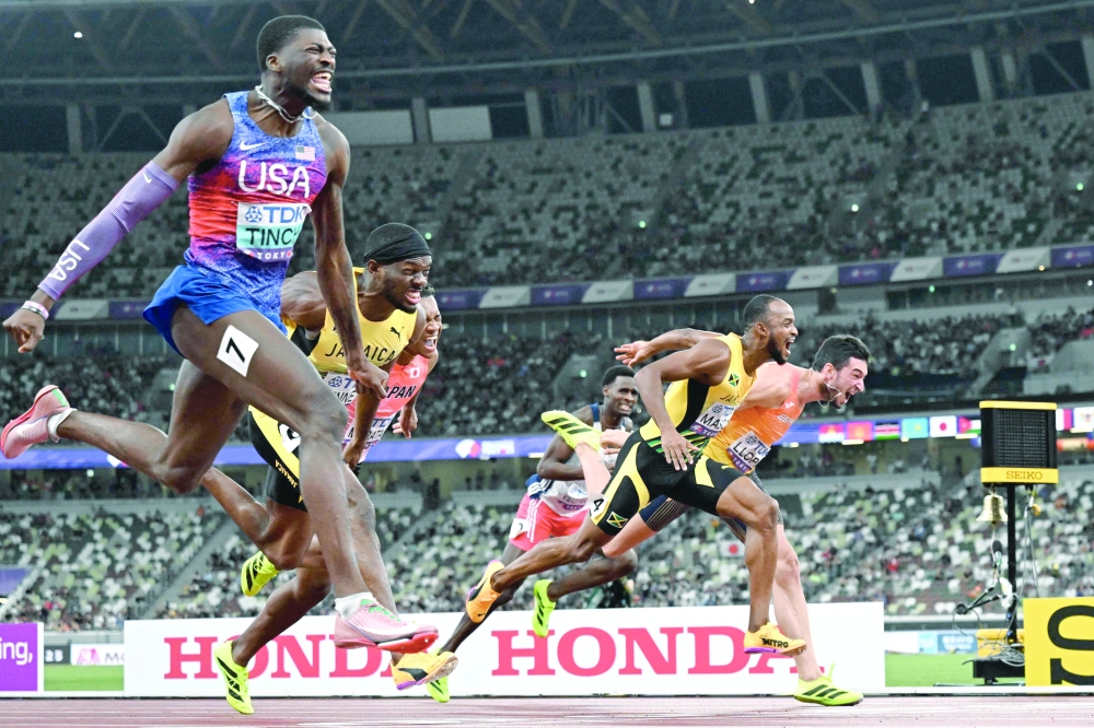US' athlete Cordell Tinch, Jamaica's athlete Orlando Bennett, Japan's athlete Rachid Muratake, Jamaica's athlete Tyler Mason and Spain's athlete Enrique Llopis cross the finish line in the men's 110m hurdles final during the World Athletics Championships in Tokyo on September 16, 2025. (Photo by Jewel SAMAD                          / AFP)
