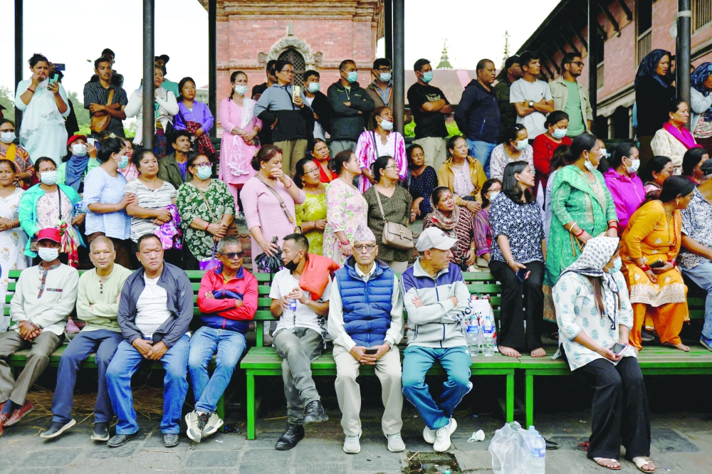 
Family members, friends gather during the cremation of the people who died in protests, in Kathmandu. — Reuters 
