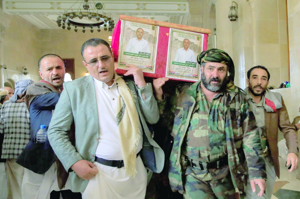 
Mourners carry caskets during a funeral for military media members, in Sanaa. — Reuters 