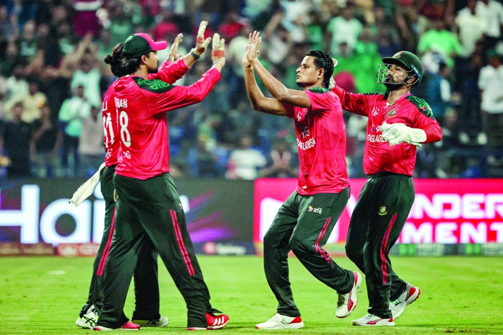 Bangladesh's wicketkeeper and captain Litton Das (R) celebrates with teammates after taking the wicket of Afghanistan's Karim Janat during the Asia Cup 2025 Twenty20 match at the Sheikh Zayed Cricket Stadium in Abu Dhabi. — AFP

