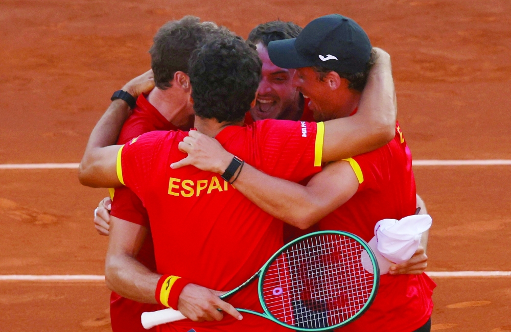 Spain's Pablo Carreno Busta and teammates celebrate after winning his singles match against Denmark's Elmer Moeller. — Reuters